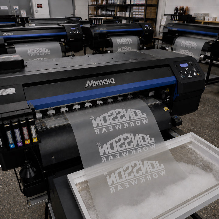 A wide-format printer laying a logo onto clear DTF film